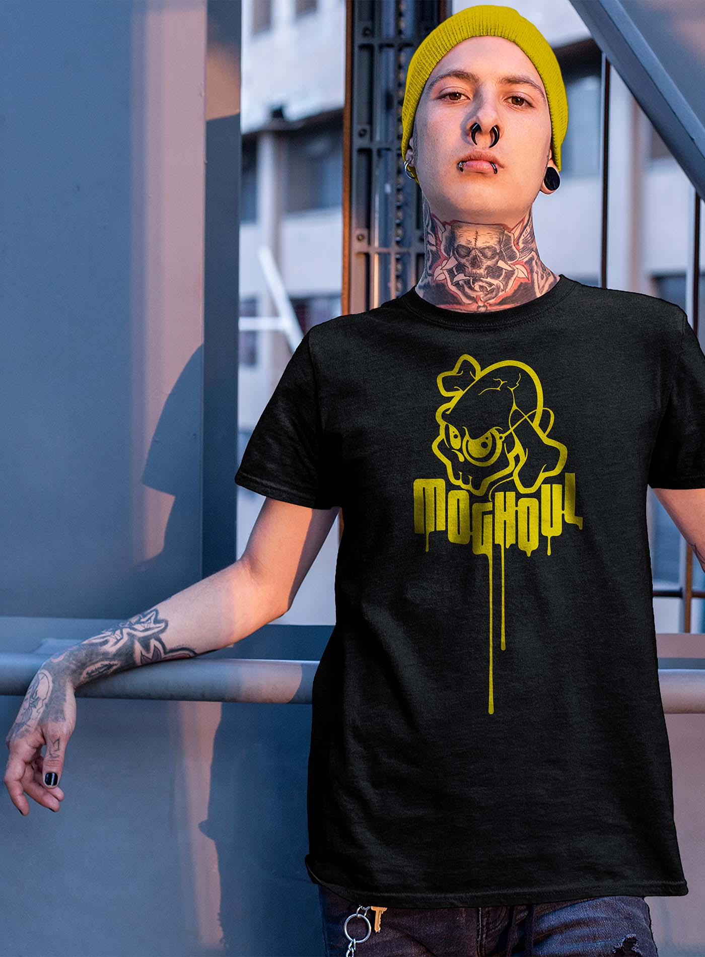 guy modeling a Heather black unisex t-shirt featuring a yellow Mr. Shade Moghoul logo by G.M. Meave.
