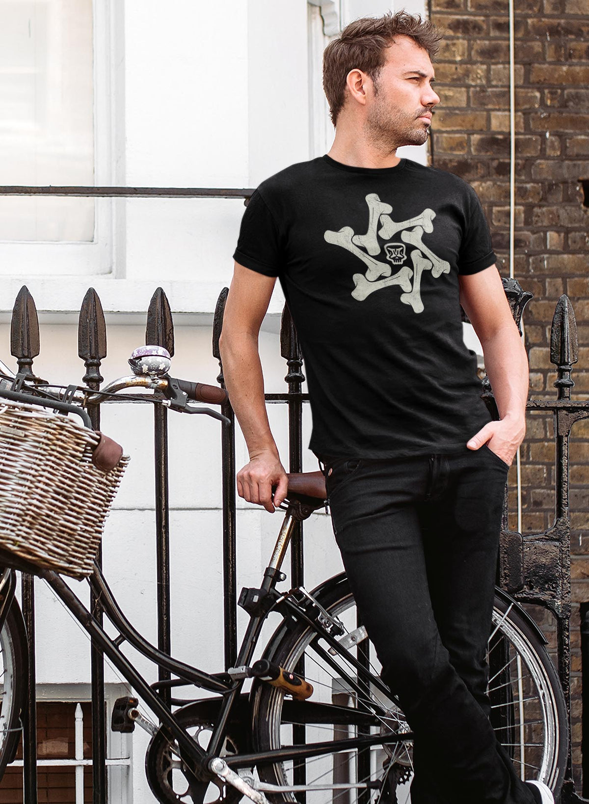 Man modeling a Heather black unisex t-shirt featuring a front print of the Moghoul symbol surrounded by a star of bones.