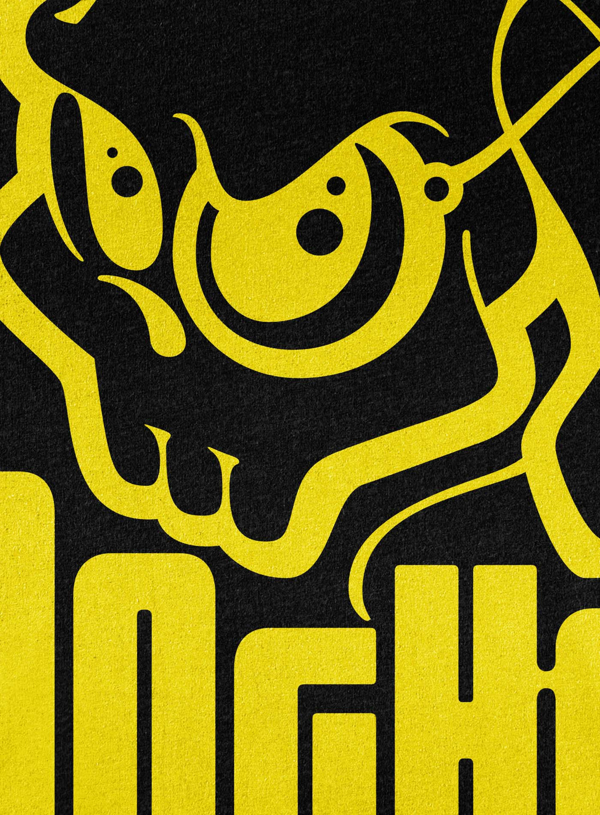 Detail of Heather black unisex t-shirt featuring a yellow Mr. Shade Moghoul logo by G.M. Meave.