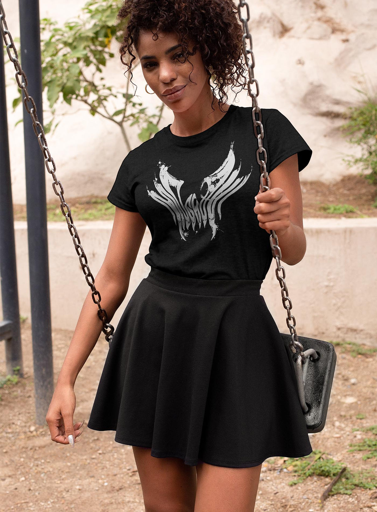 Woman modeling a Black unisex t-shirt featuring a front print of the black Mr. Splatter Moghoul logo by Sasha Sidorovich