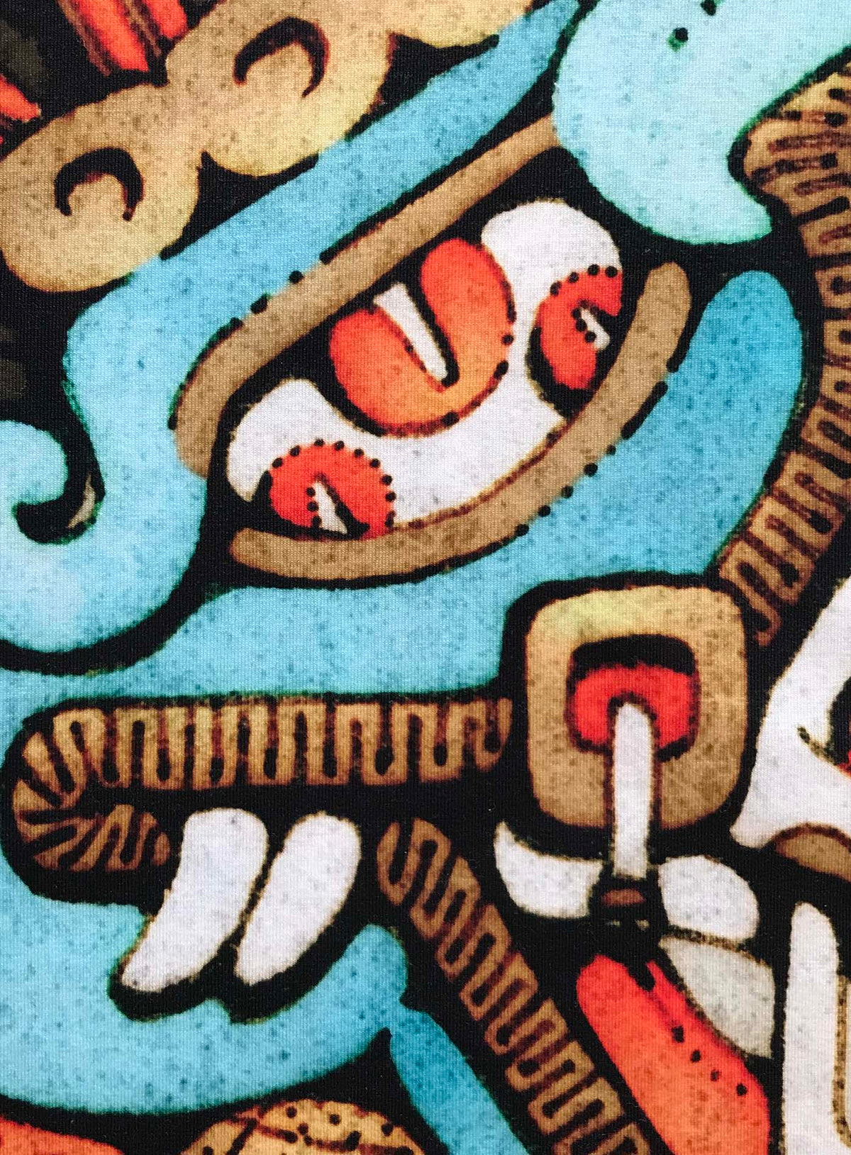 Detail of an All over dye sublimation t-shirt featuring an illustration of the Aztec god Tezcatlipoca by G.M. Meave.
