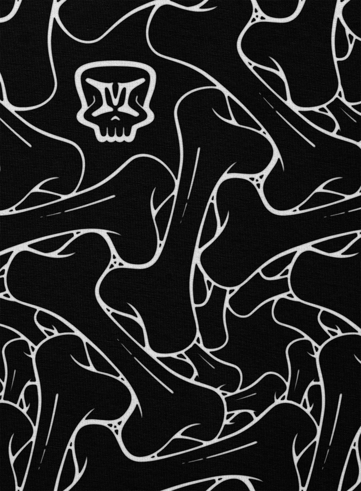 Detail of an all over dye sublimation t-shirt featuring the Moghoul symbol surrounded by a patter of bones based on Islamic ornamental art.