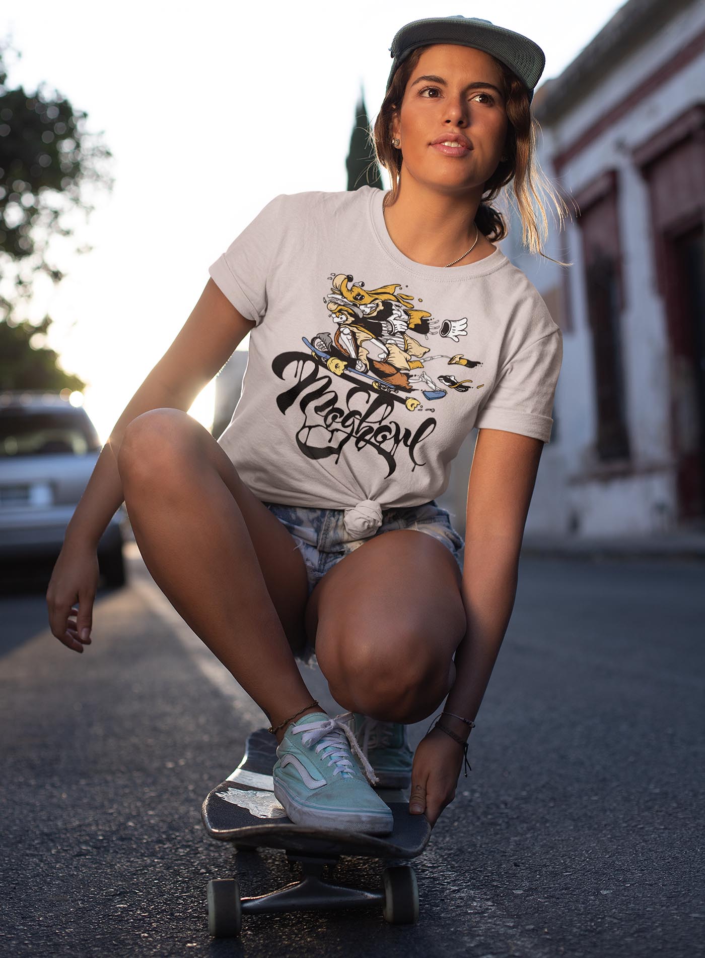 Female modeling a heather beige unisex t-shirt featuring a front print of Doom Dawg by street artist Carson Ting, and the Moghoul logo.