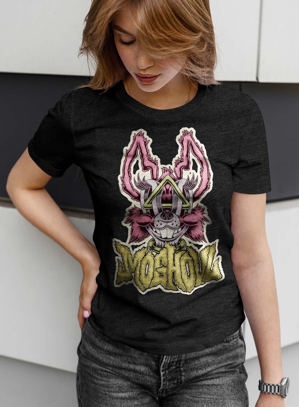 Female modeling a Heather black unisex t-shirt featuring a front print of a dog and the Moghoul logo rendered in urban art style by Jason Hankins aka Jazmo.