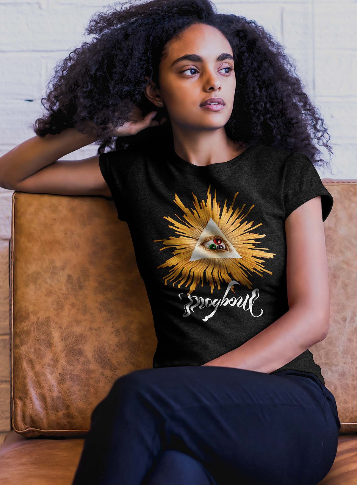 Female modeling a Heather black unisex t-shirt featuring a front print of a reinterpretation of the Horus pyramid and Moghoul ambigram logo by G.M. Meave.