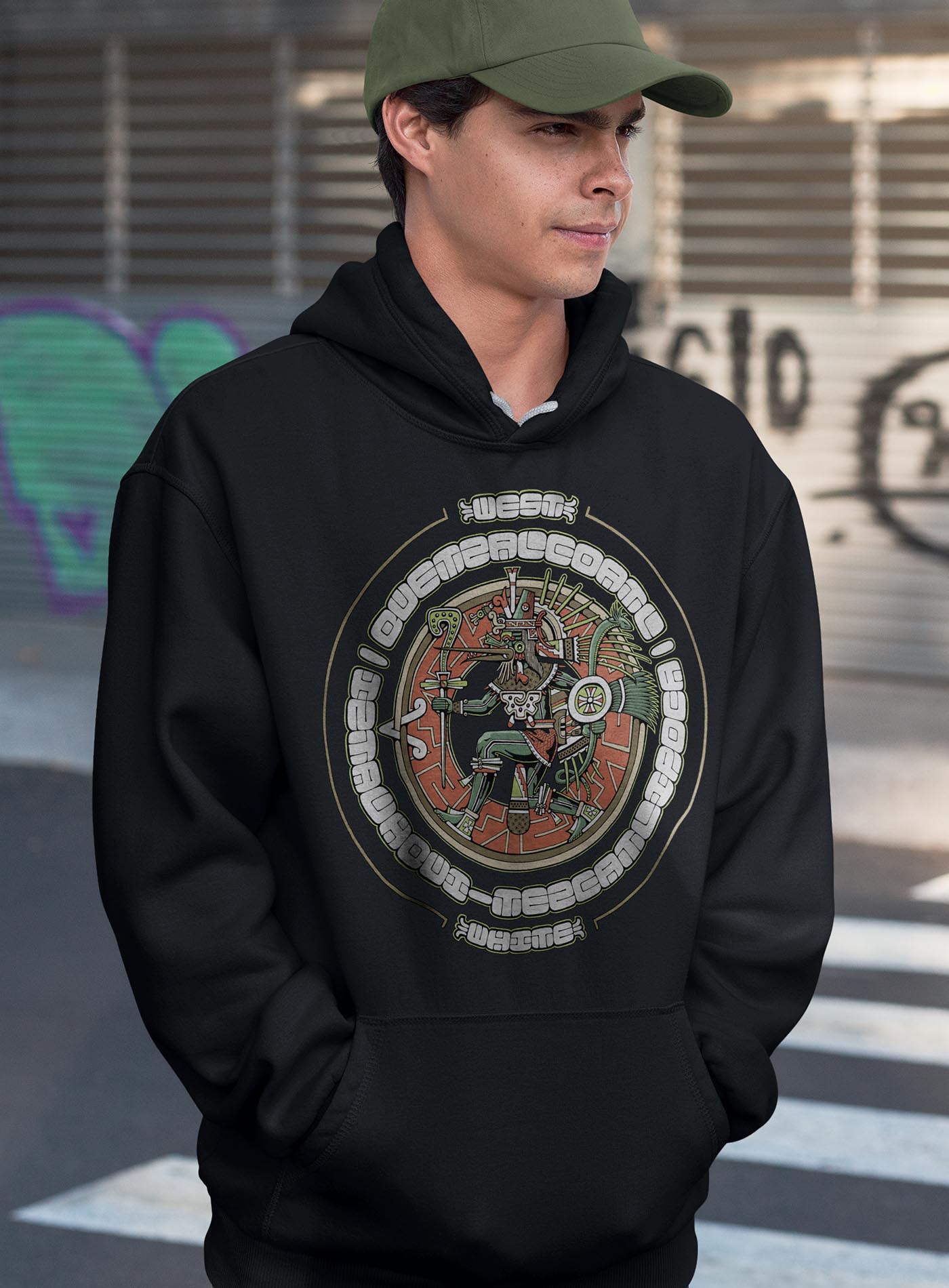 man modeling a black unisex hoodie featuring a front print of the toltec-aztec god Tezcatlipoca also known as Quetzalcoatl. Reinterpretation by Mexican illustrator G.M. Meave.