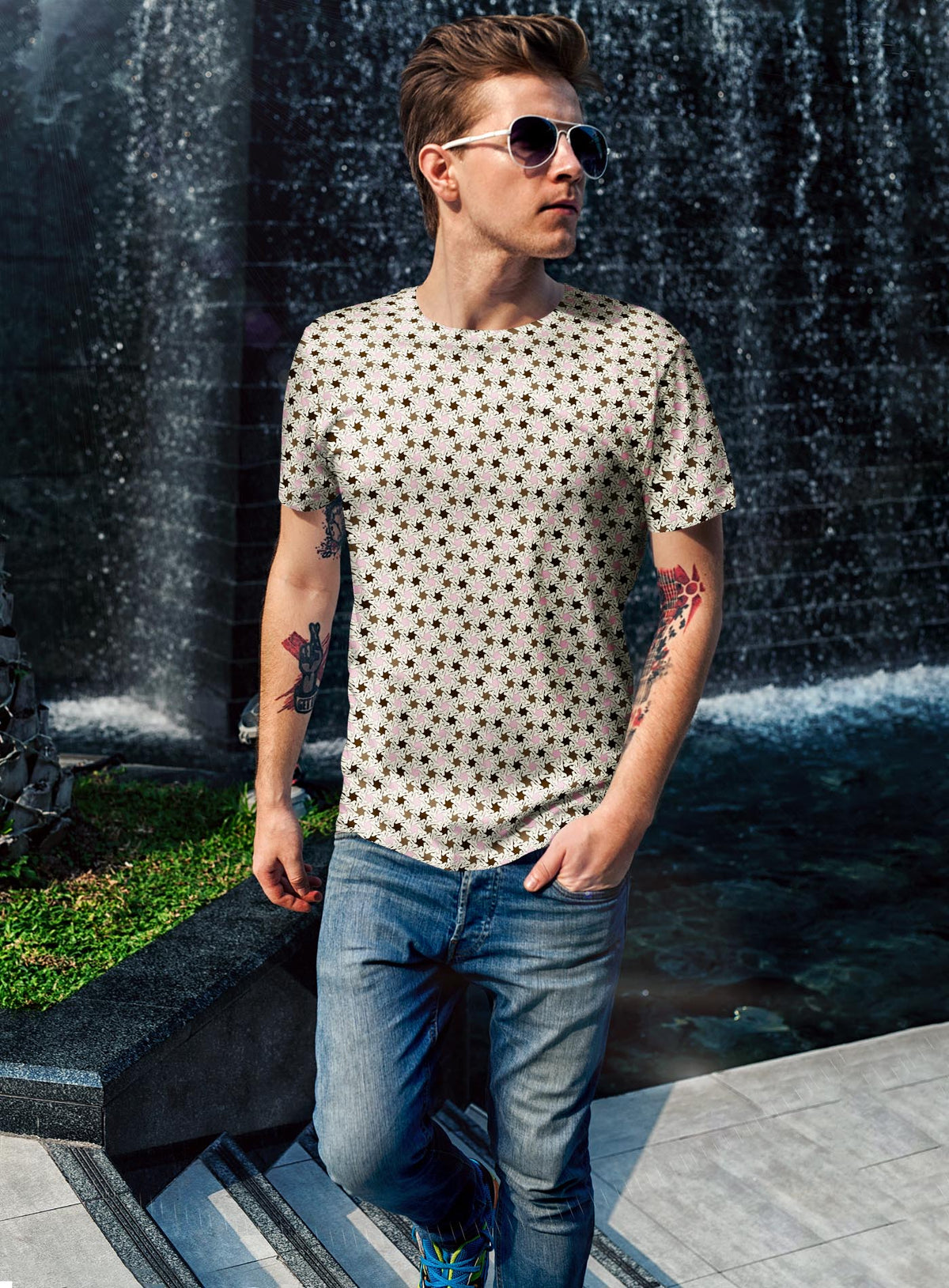 Man modeling an All over dye sublimation t-shirt featuring a patter of bones based on Islamic ornamental art in brown and pink colors.
