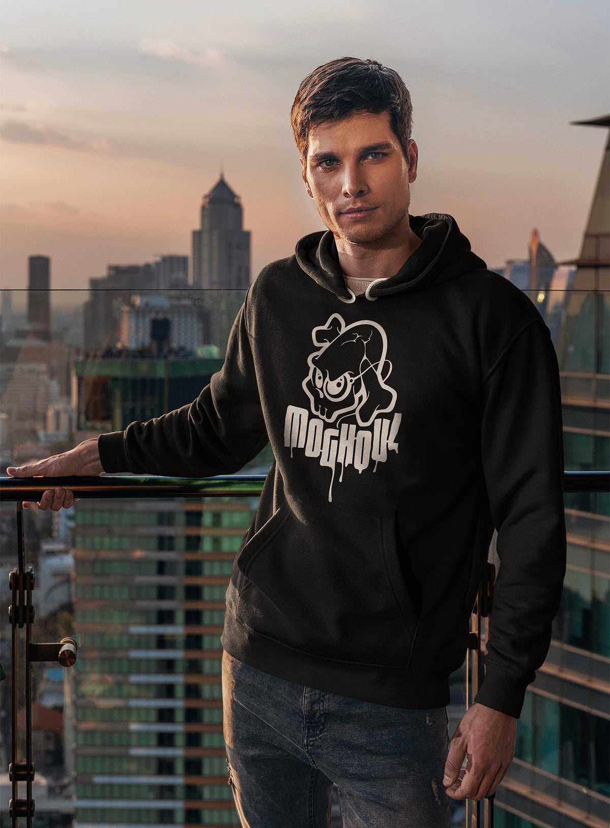 man modeling a Black unisex hoodie featuring a white Mr. Shade Moghoul logo by G.M. Meave.