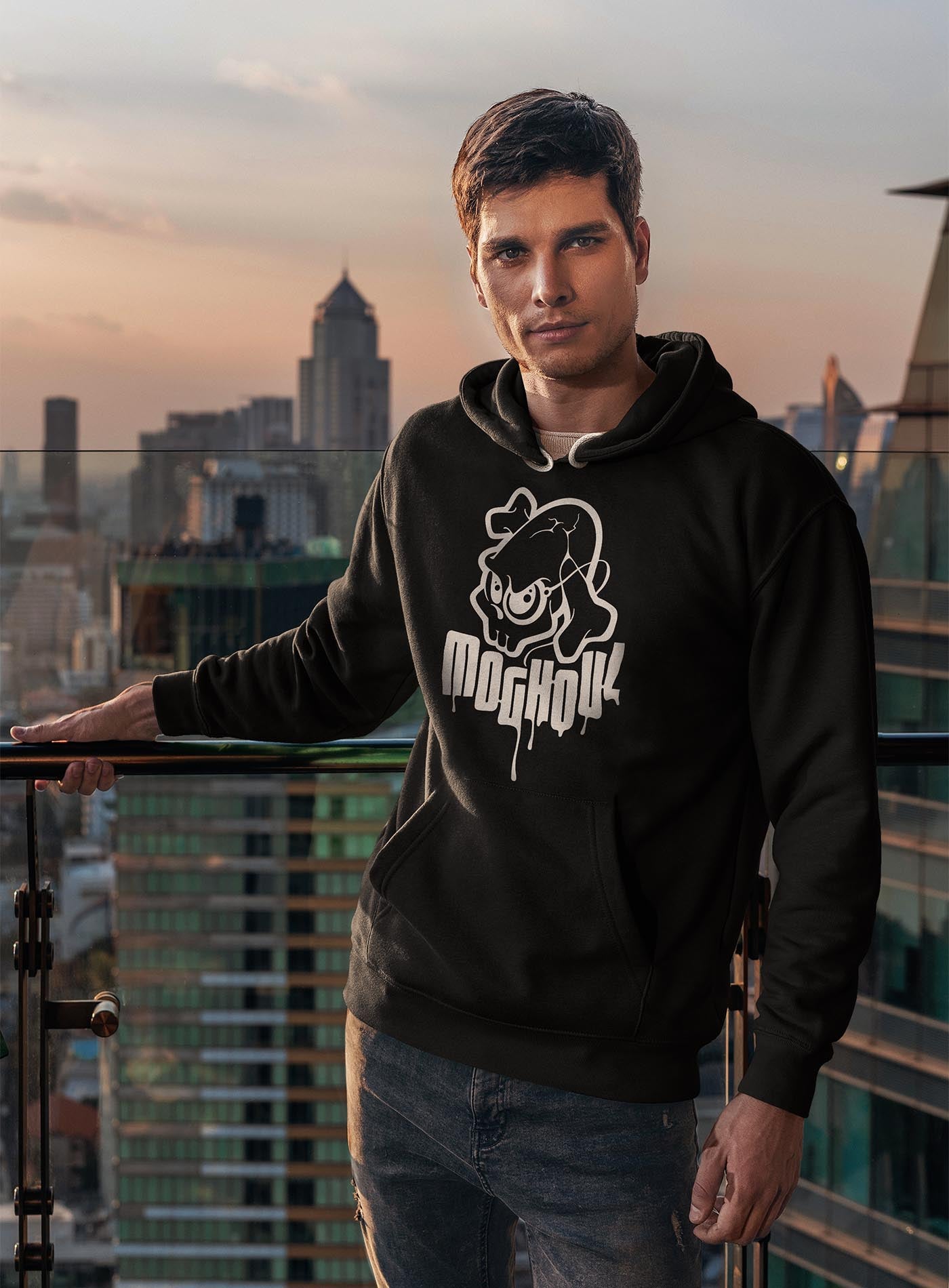 man modeling a Black unisex hoodie featuring a white Mr. Shade Moghoul logo by G.M. Meave.