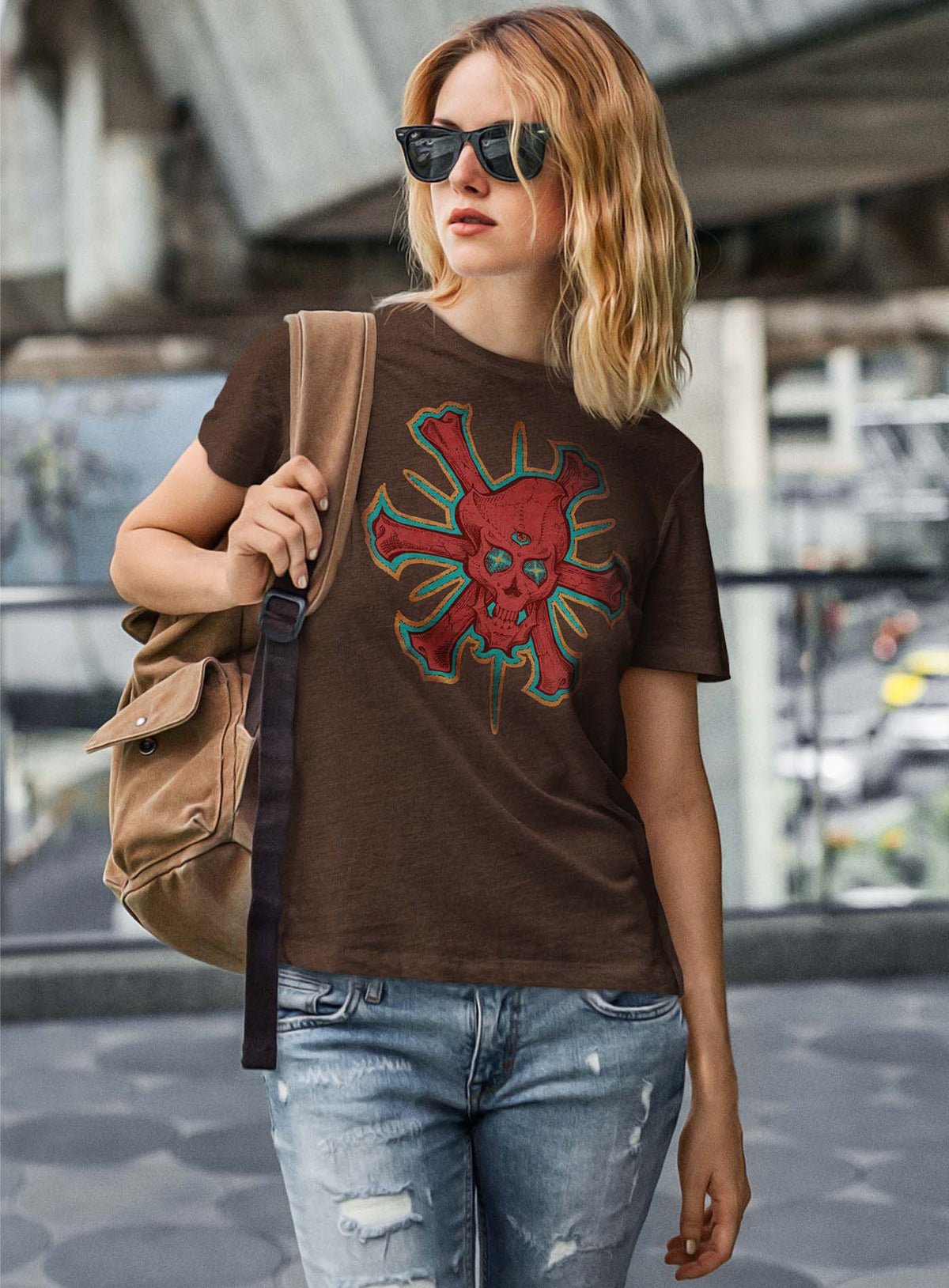 Female modeling a Heather brown unisex t-shirt featuring a front print of a three-bone alien Jolly Roger pirate illustration by G.M. Meave.