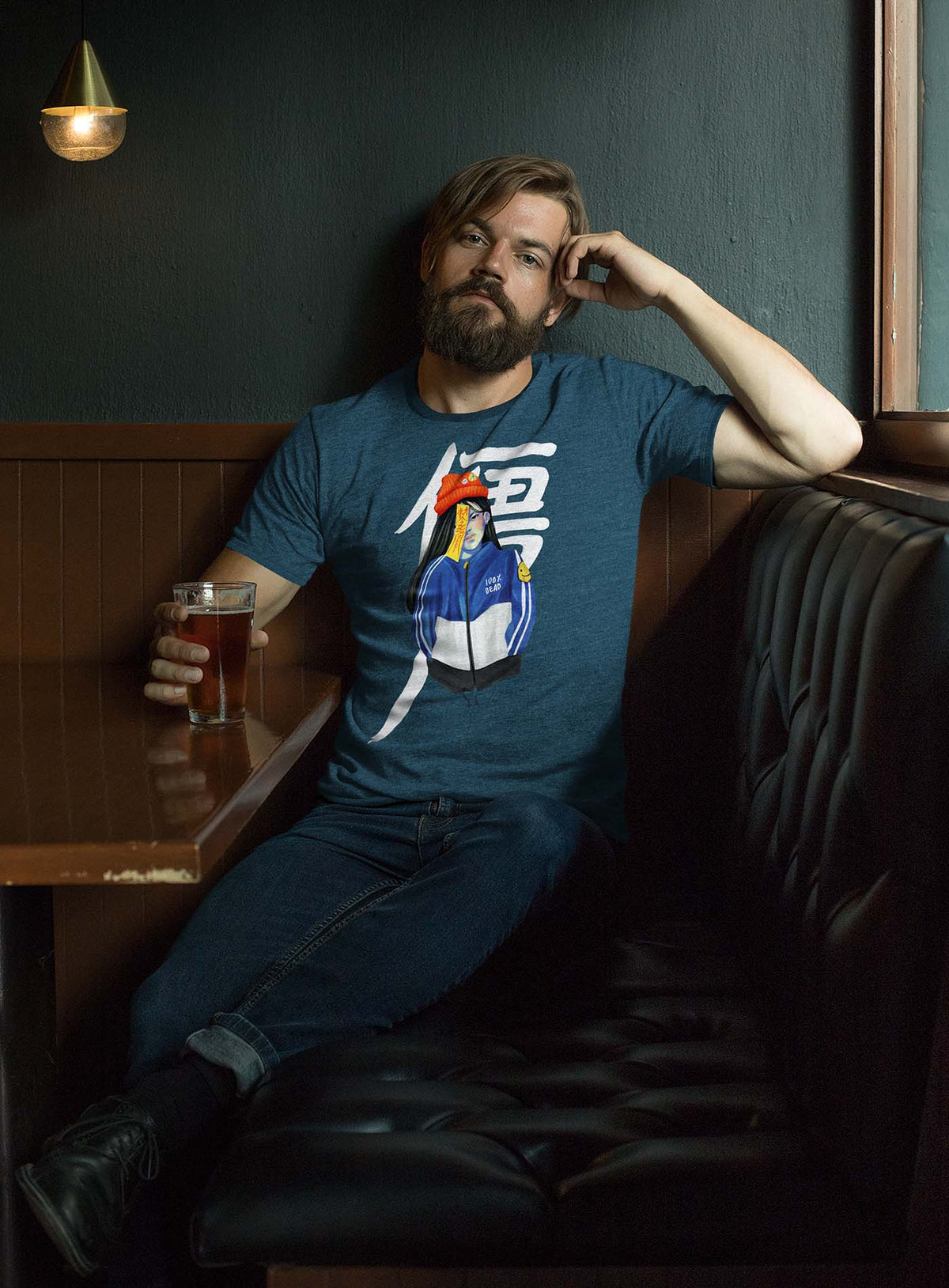 Man modeling a Heather blue unisex t-shirt featuring a front print of a jiangshi Chinese zombie in urban outfit illustrated by Aiken Lao.