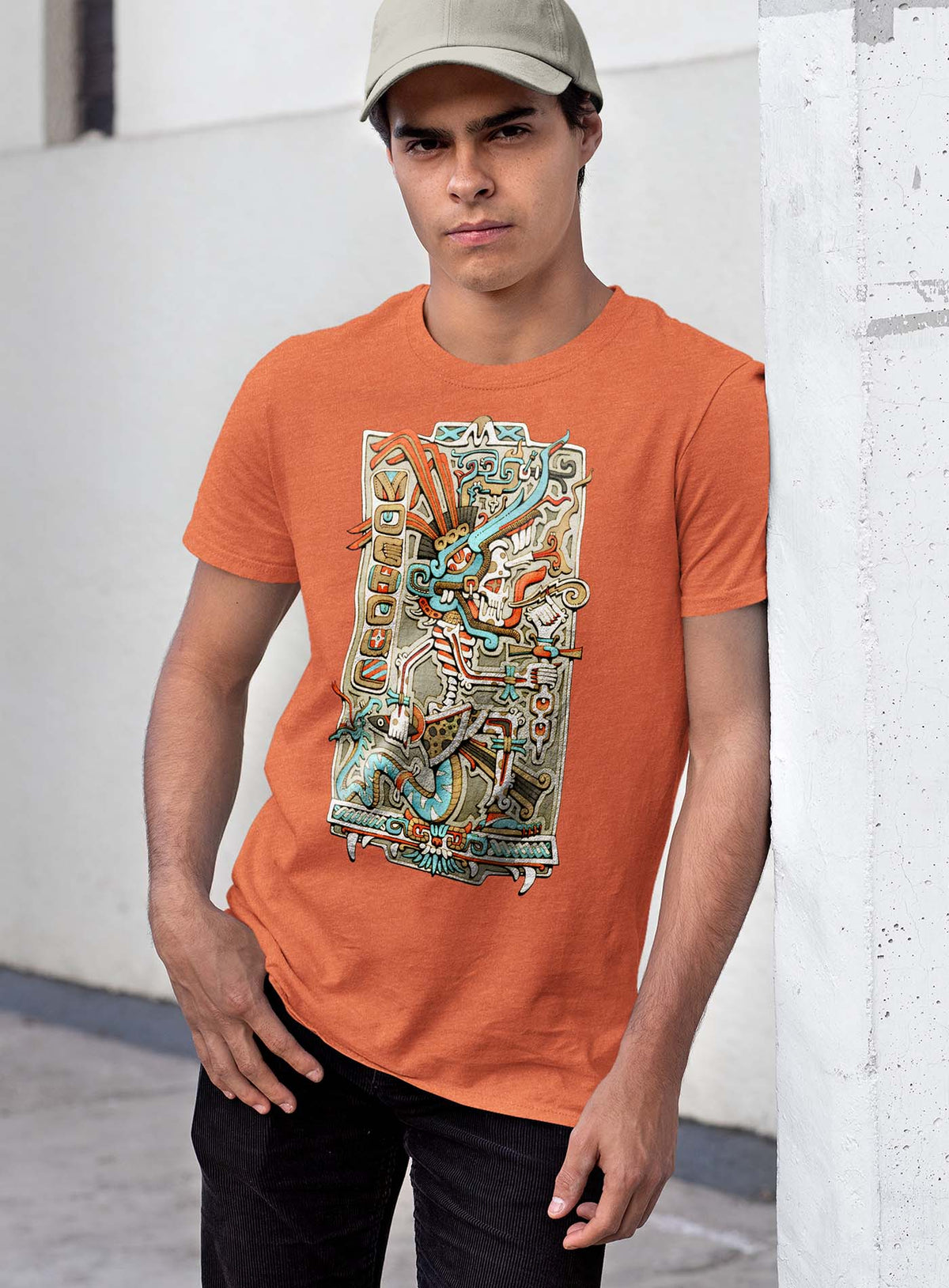 Man modeling a Heather orange unisex t-shirt featuring a front print of the Aztec god Tezcatlipoca illustrated by G.M. Meave.