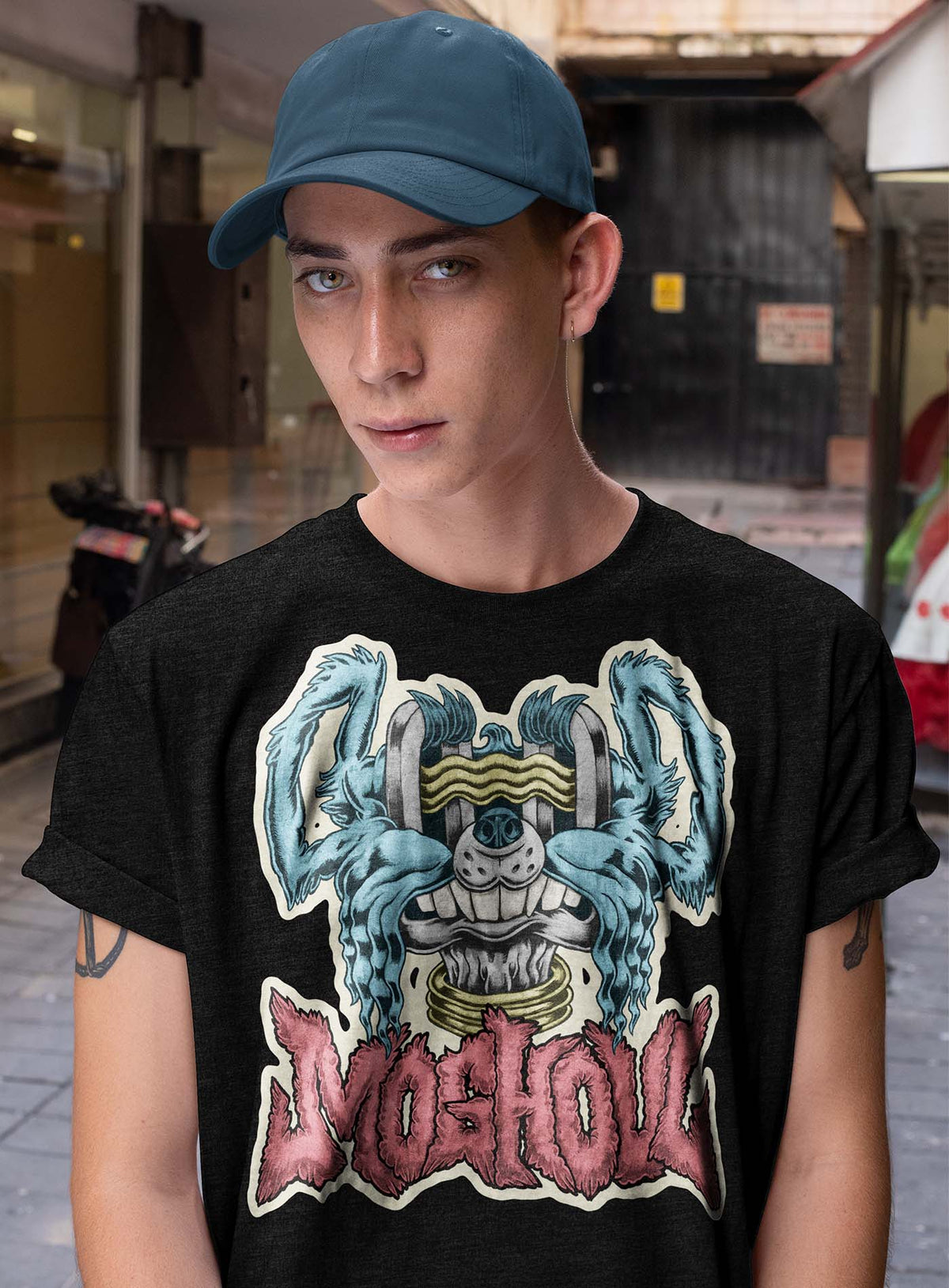 Guy modeling a Heather black unisex t-shirt featuring a front print of a dog and the Moghoul logo rendered in urban art style by Jason Hankins aka Jazmo.
