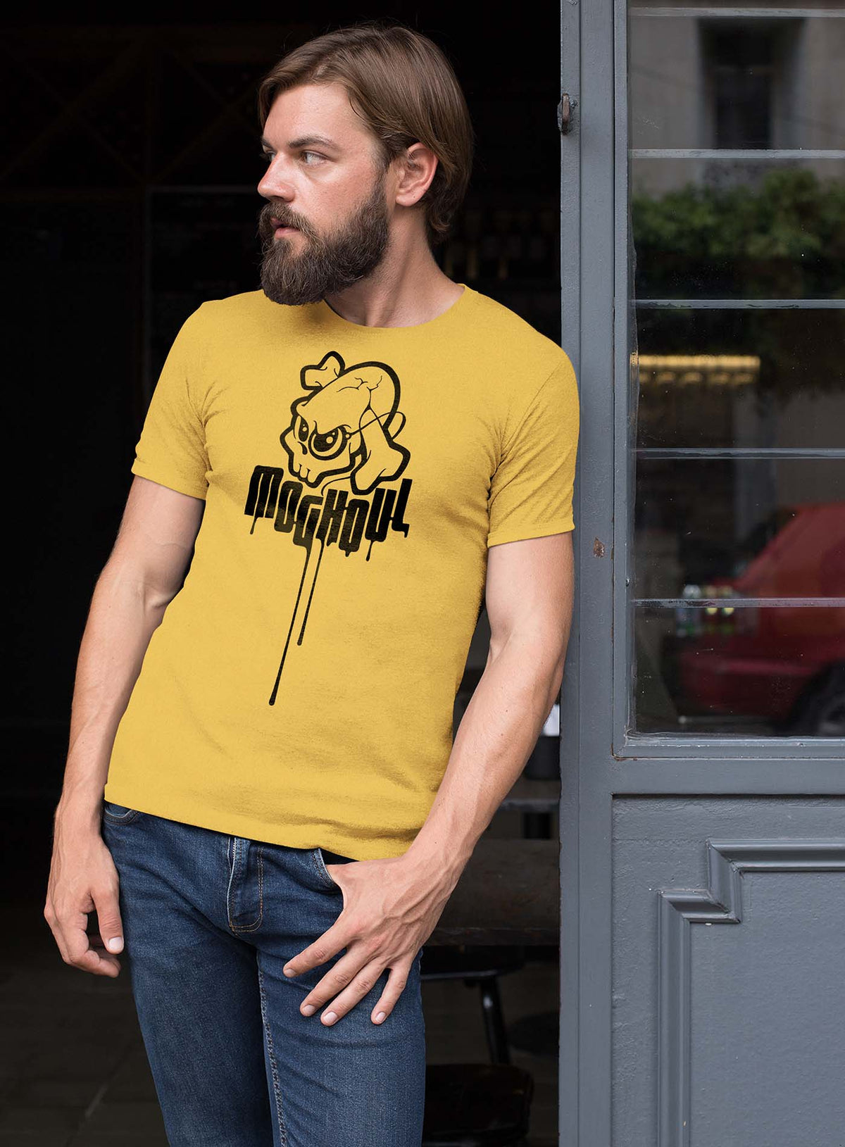 Man modeling a yellow unisex t-shirt featuring a yellow Mr. Shade Moghoul logo by G.M. Meave.