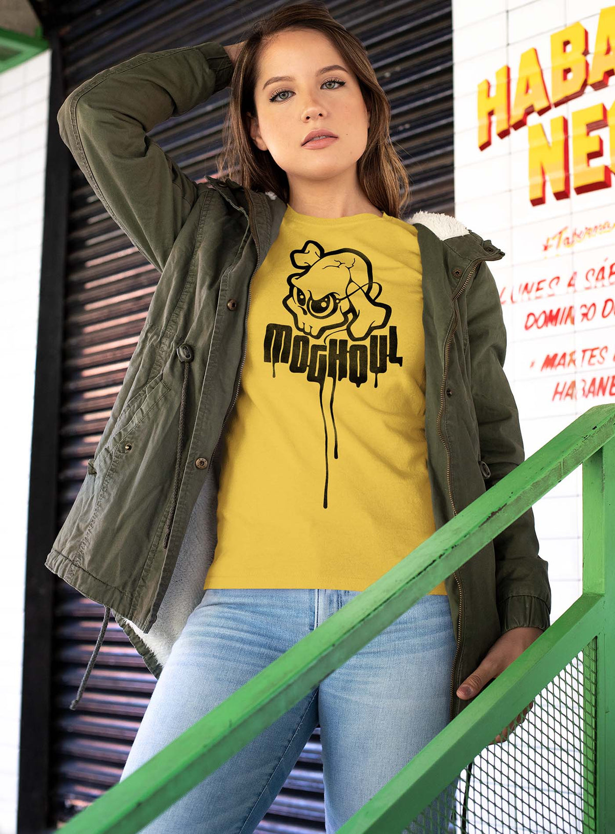 Woman modeling a yellow unisex t-shirt featuring a yellow Mr. Shade Moghoul logo by G.M. Meave.