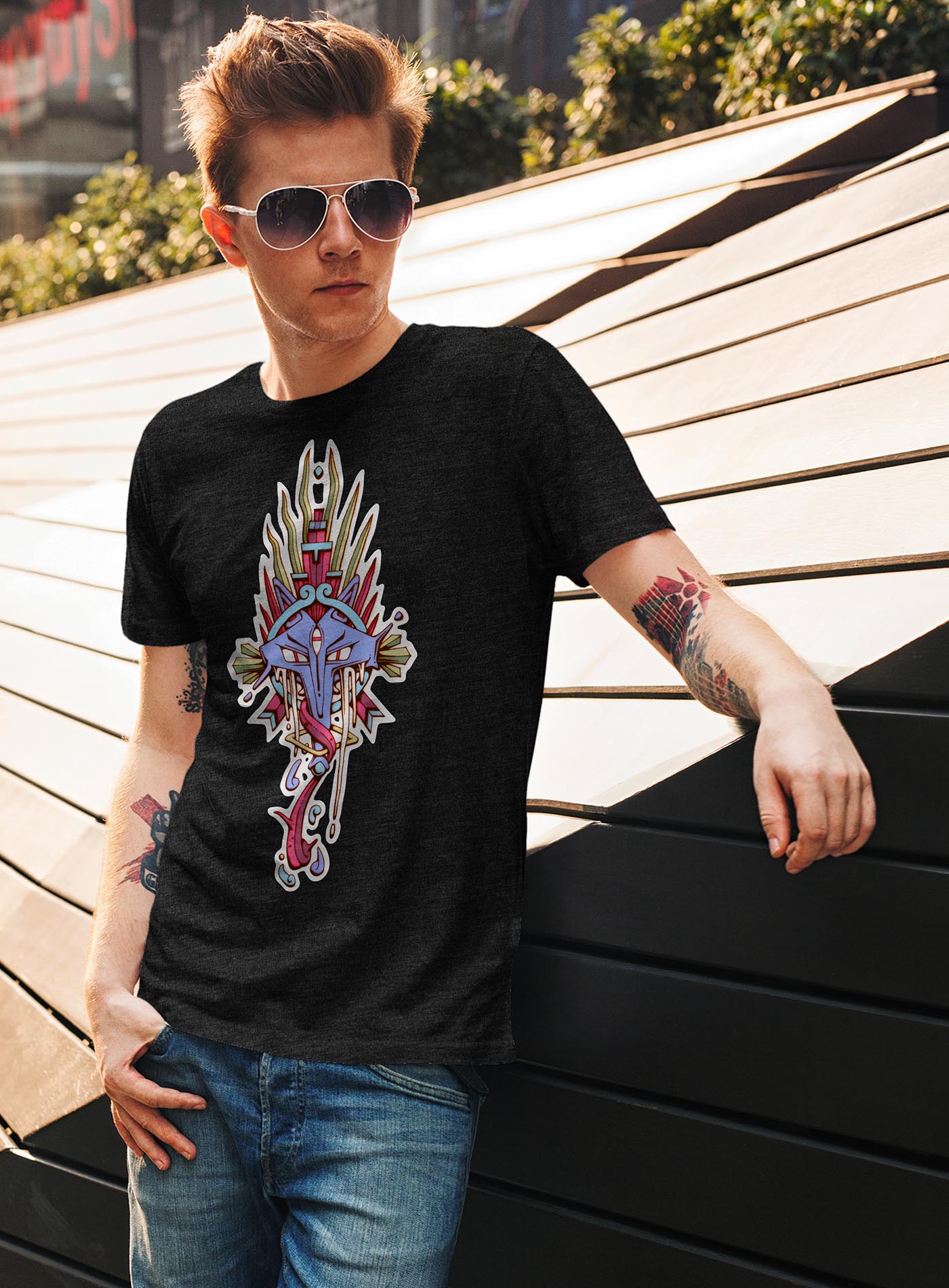 man modeling a heather black unisex t-shirt featuring a front print of the Toltec and Aztec coyote deity illustrated by G.M. Meave