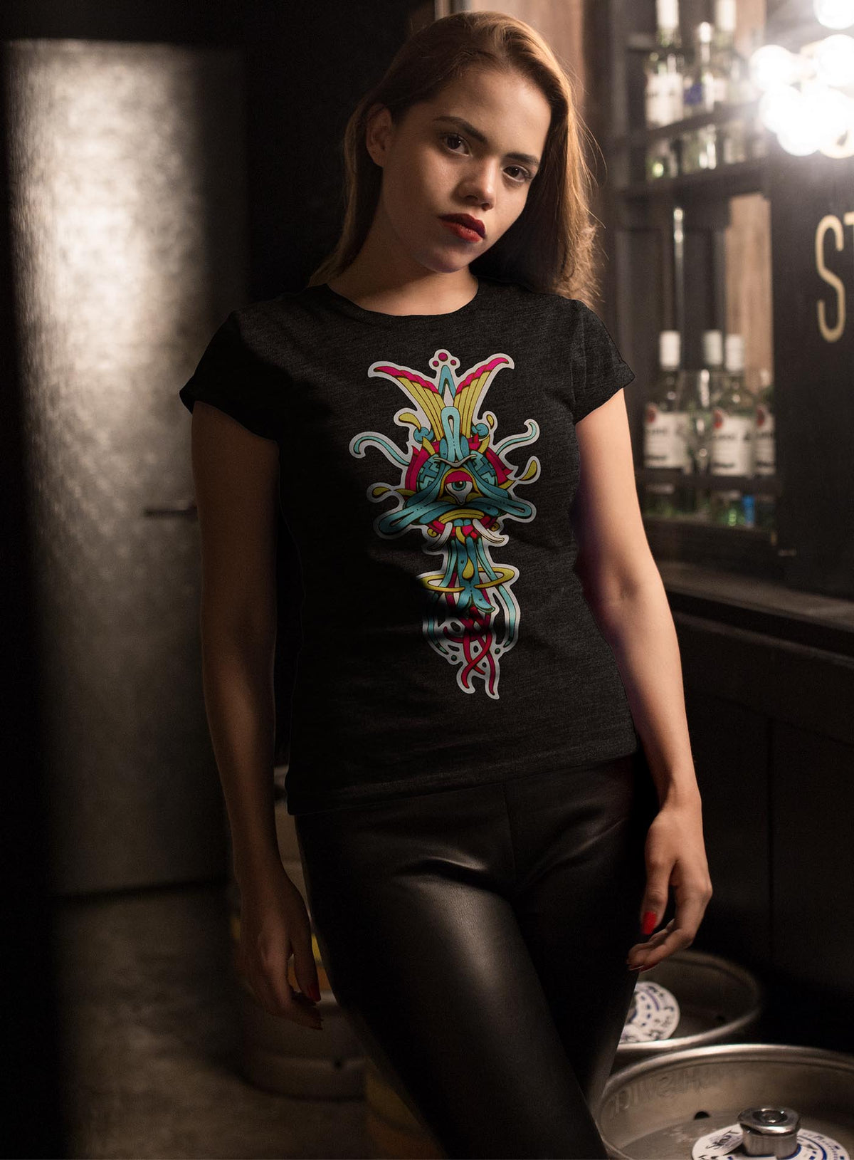 Woman modeling a Heather black unisex t-shirt featuring a front print of the Toltec-Aztec goddess of grass illustrated by G.M. Meave