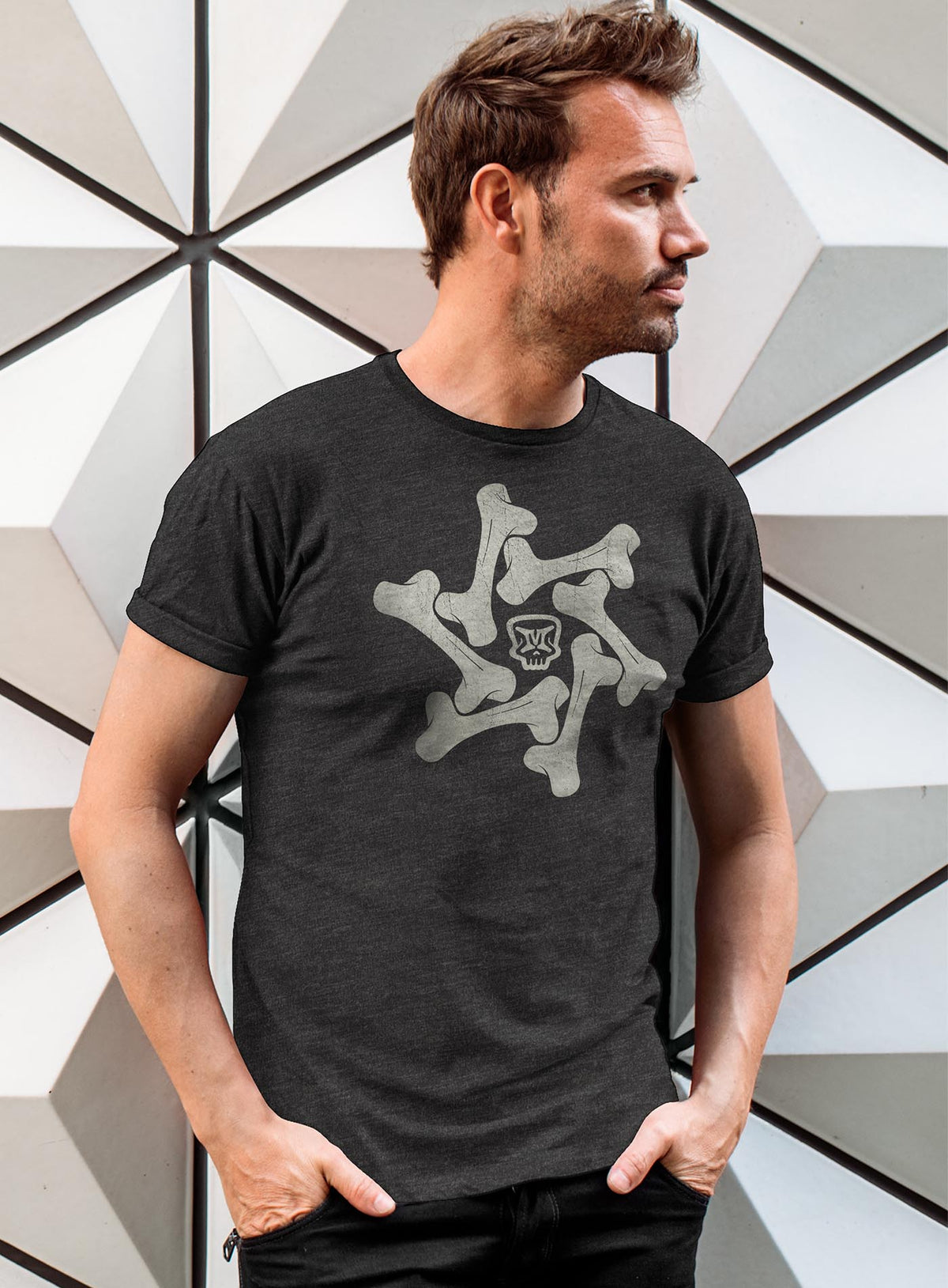 Man modeling a  Heather gray unisex t-shirt featuring a front print of the Moghoul symbol surrounded by a star of bones.