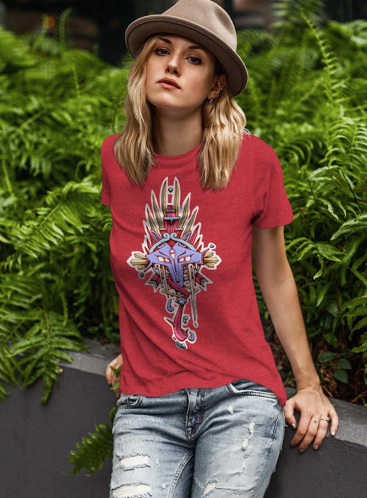 Woman modeling a heather red unisex t-shirt featuring a front print of the Toltec and Aztec coyote deity illustrated by G.M. Meave
